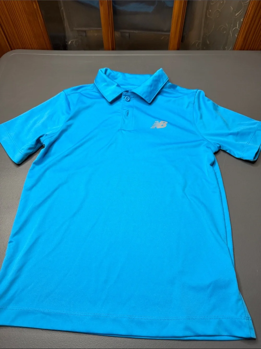Kid’s New Balance Bright Blue Polo and Black Athletic Shorts Set. Size: 8